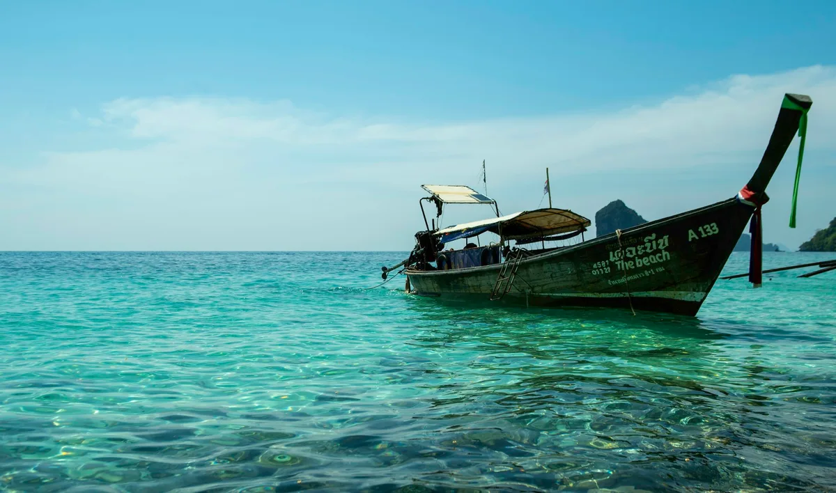Longtail boat and limestone cliffs in Thailand